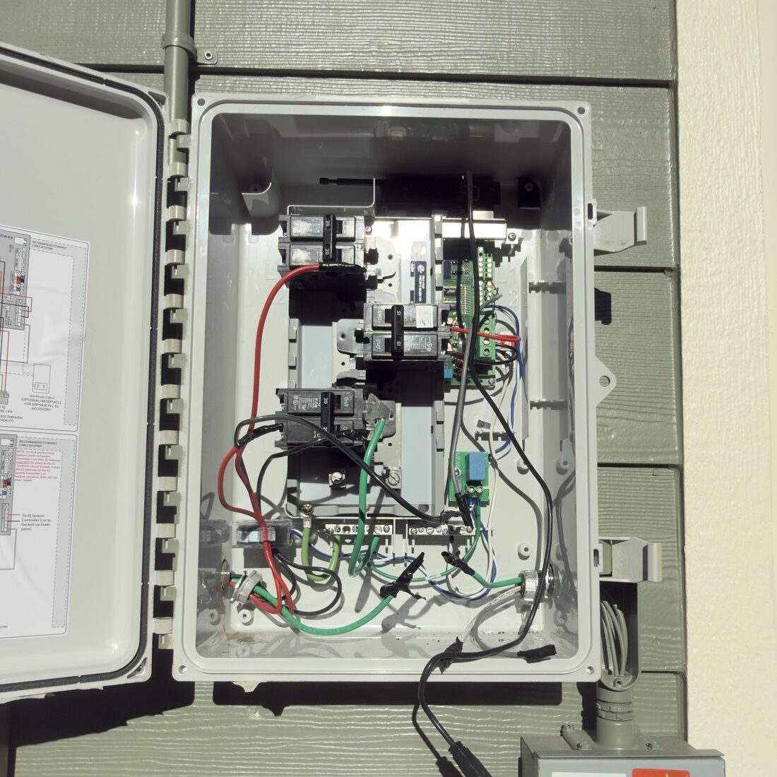 Open combiner box showing Enphase IQ wiring