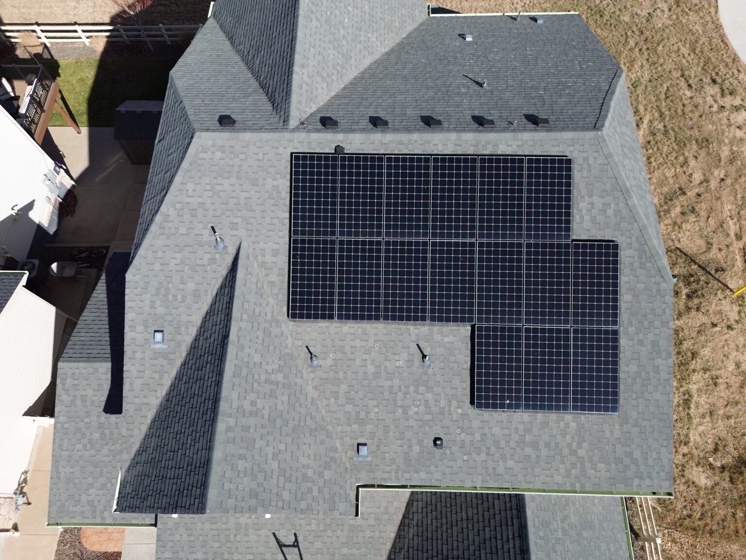 Drone aerial view of solar panel array on residential roof