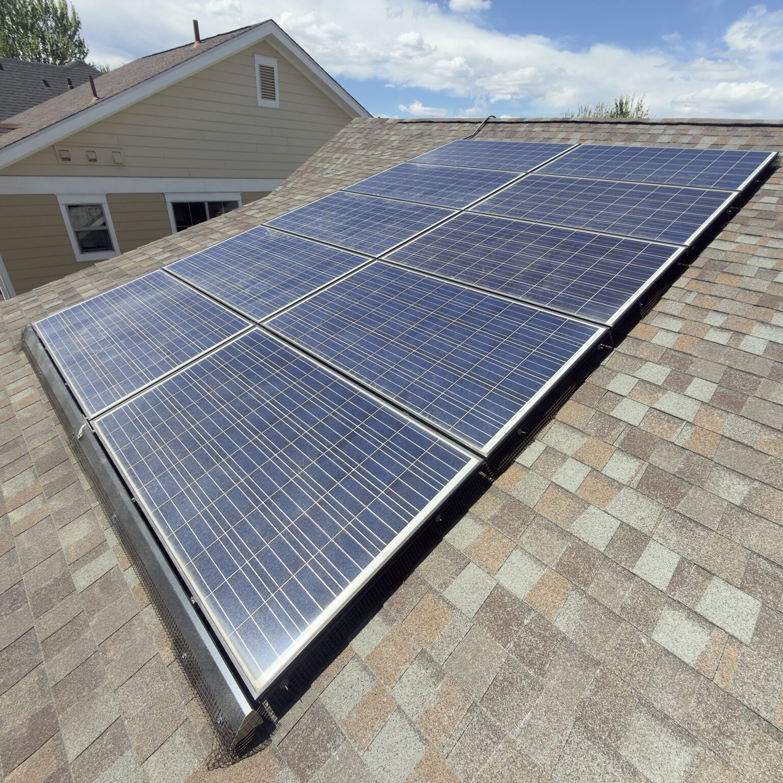 9-panel residential solar array on shingle roof